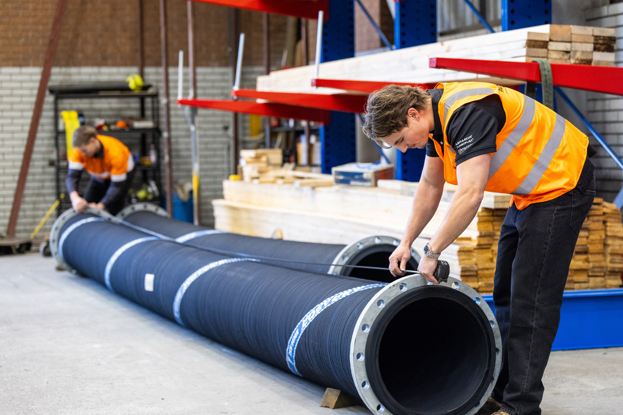 2 employee from pacific flow technology check the quality of hose